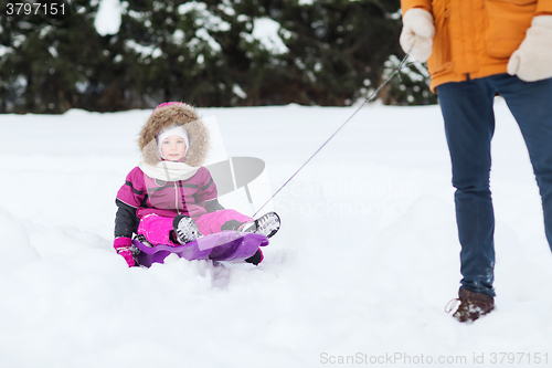 Image of happy little kid on sled outdoors in winter