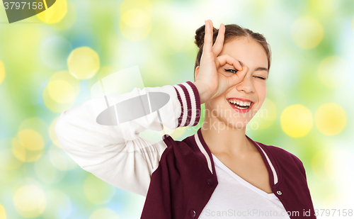 Image of happy teenage girl making face and having fun