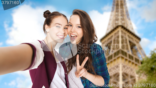 Image of happy friends taking selfie over eiffel tower