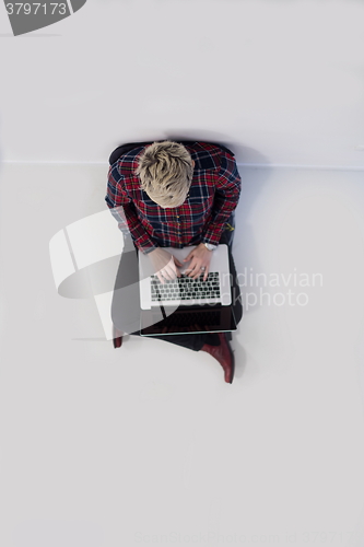 Image of top view of young business woman working on laptop computer
