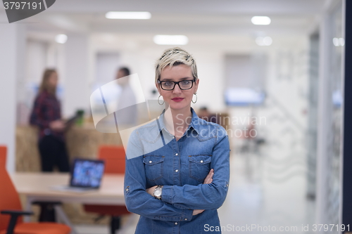 Image of portrait of young business woman at office with team in backgrou