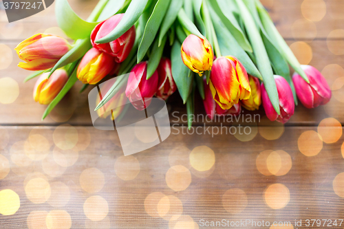 Image of close up of tulip flowers on wooden table