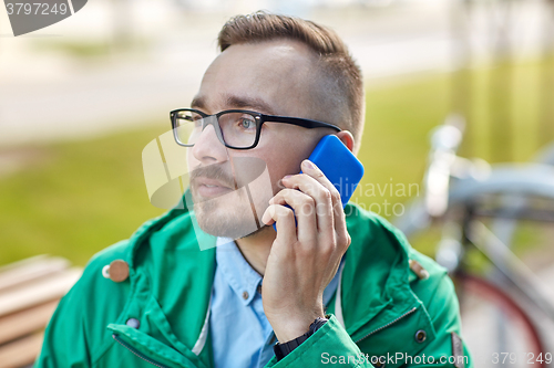 Image of young hipster man calling on smartphone