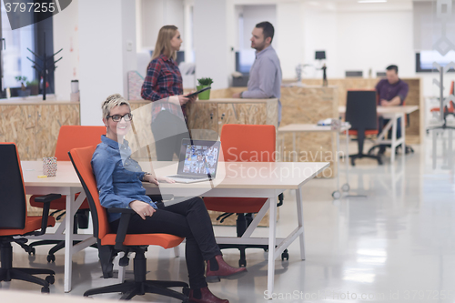 Image of portrait of young business woman at office with team in backgrou