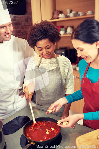 Image of happy women and chef cook cooking in kitchen