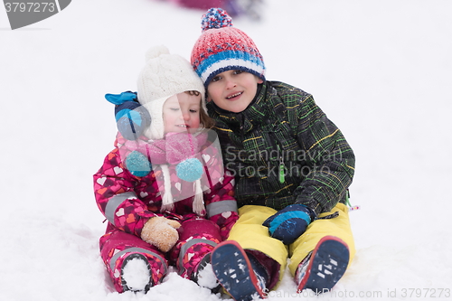 Image of group of kids having fun and play together in fresh snow