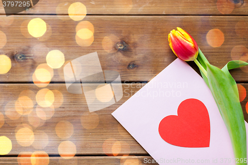 Image of close up of flowers and greeting card with heart