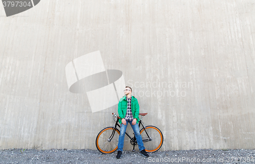 Image of happy young hipster man with fixed gear bike