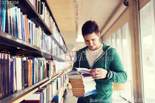 Image of happy student or man with book in library