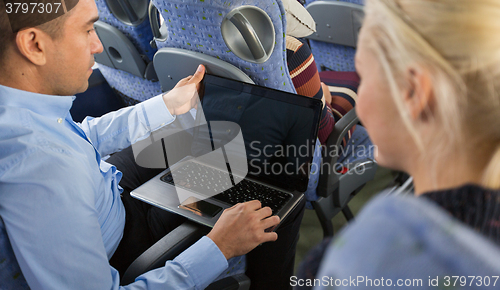 Image of close up of passengers with laptop in travel bus