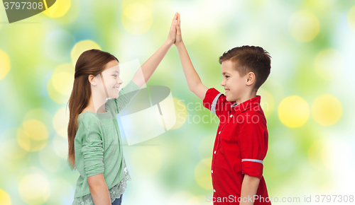 Image of happy boy and girl making high five