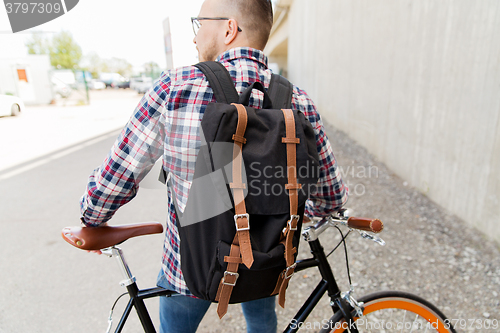 Image of hipster man with fixed gear bike and backpack