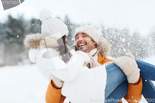 Image of happy couple outdoors in winter