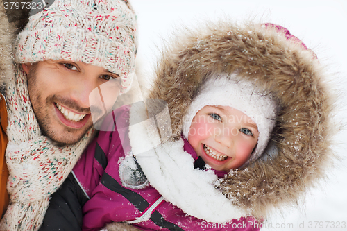 Image of happy family in winter clothes outdoors