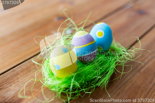 Image of close up of colored easter eggs and grass