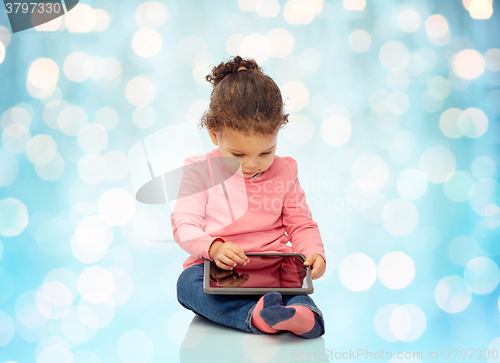 Image of little baby girl playing with tablet pc computer