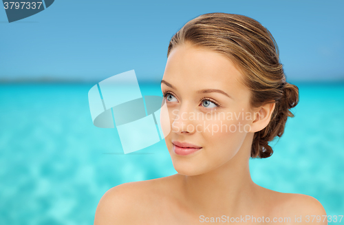 Image of smiling young woman face and shoulders