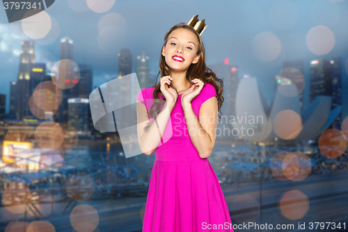 Image of happy young woman or teen girl in pink dress