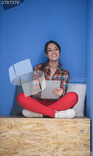Image of woman in crative box working on tablet