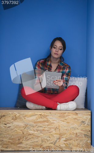 Image of woman in crative box working on tablet