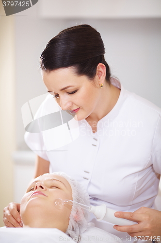 Image of Woman under facial spa procedure