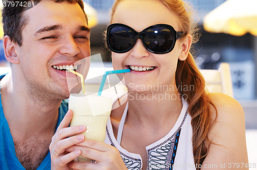 Image of Romantic couple sharing a cocktail