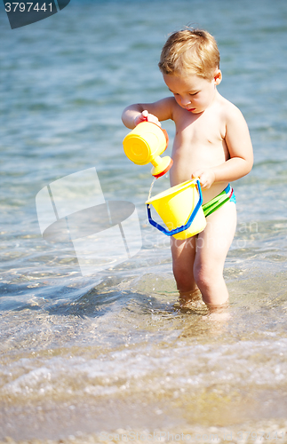 Image of Adorable little boy playing in the sea