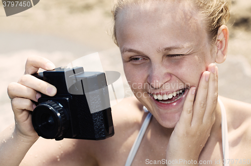 Image of Woman laughing as she views a photo