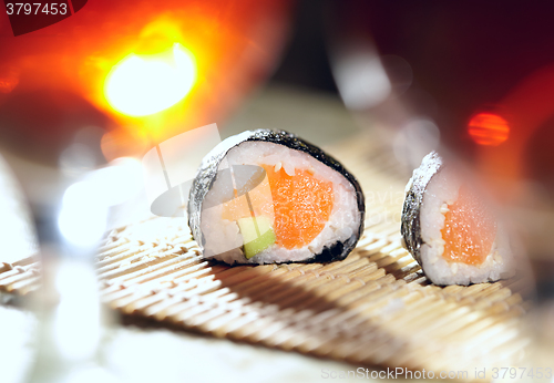 Image of Sushi rolls and plum wine.