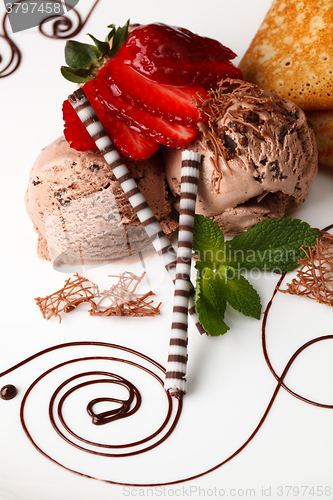 Image of Chocolate ice cream topped with fresh strawberries