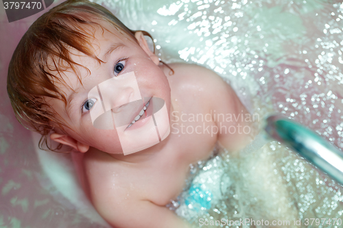 Image of Little boy takes a bath.