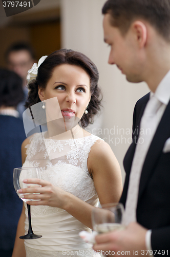 Image of Bride and groom enjoy a drink at the wedding