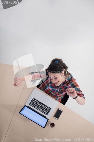 Image of top view of young business woman working on laptop