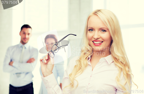 Image of smiling businesswoman or secretary in office