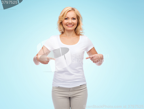 Image of smiling woman in white t-shirt pointing to herself