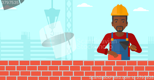 Image of Bricklayer with spatula and brick.