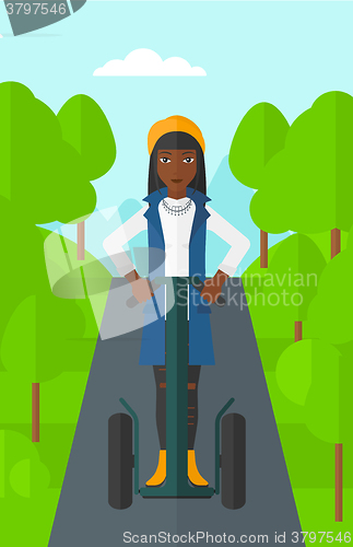 Image of Woman riding on electric scooter.