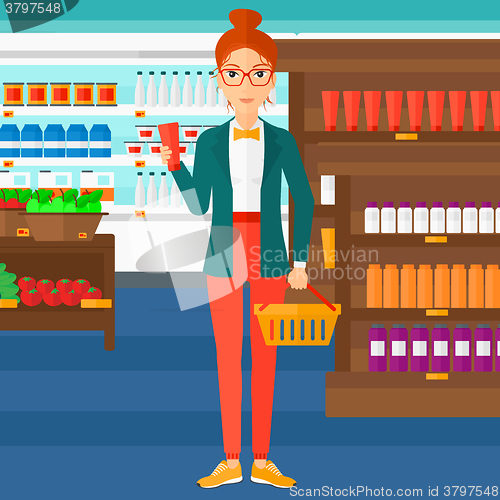 Image of Customer with shopping basket and tube of cream.