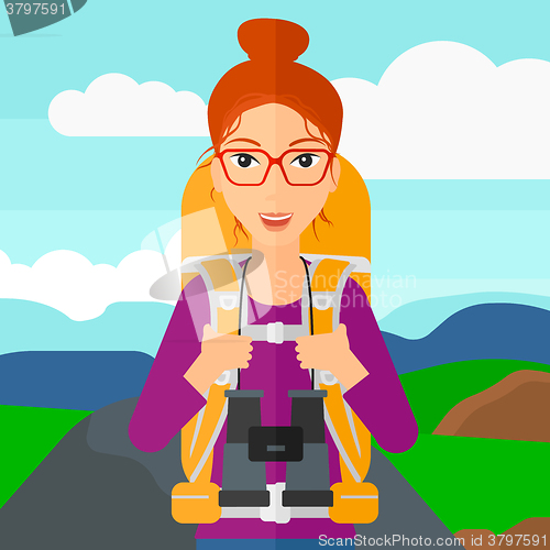 Image of Cheerful backpacker with binoculars.
