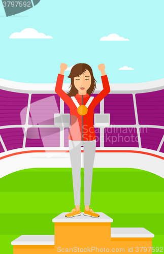 Image of Athlete with medal and hands raised.