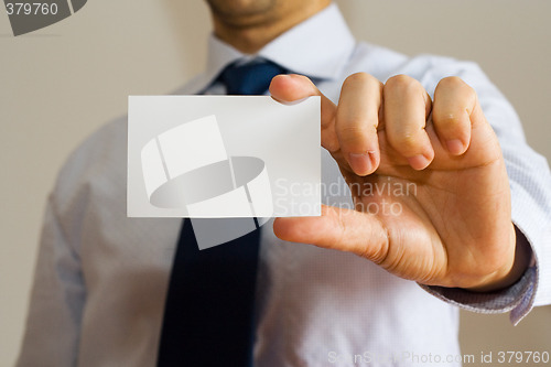 Image of Business man holding a name card