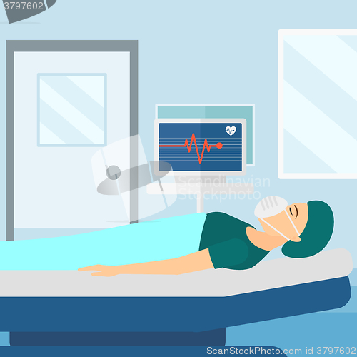 Image of Patient lying in hospital bed with heart monitor.