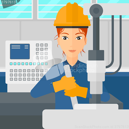 Image of Woman working with industrial equipment.