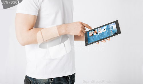 Image of close up of man with business news on tablet pc