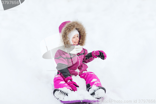 Image of happy little kid on sled outdoors in winter