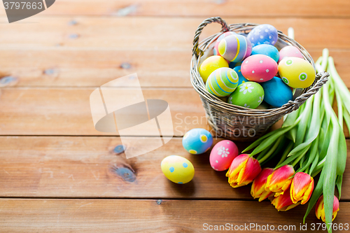 Image of close up of easter eggs in basket and flowers