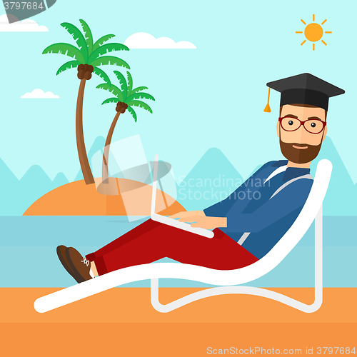 Image of Graduate lying on chaise lounge with laptop.