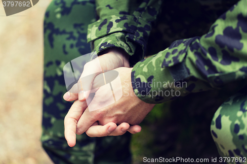 Image of close up of young soldier in military uniform