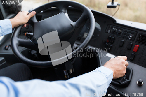 Image of close up of driver driving passenger bus