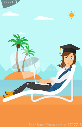 Image of Graduate lying on chaise lounge with laptop.